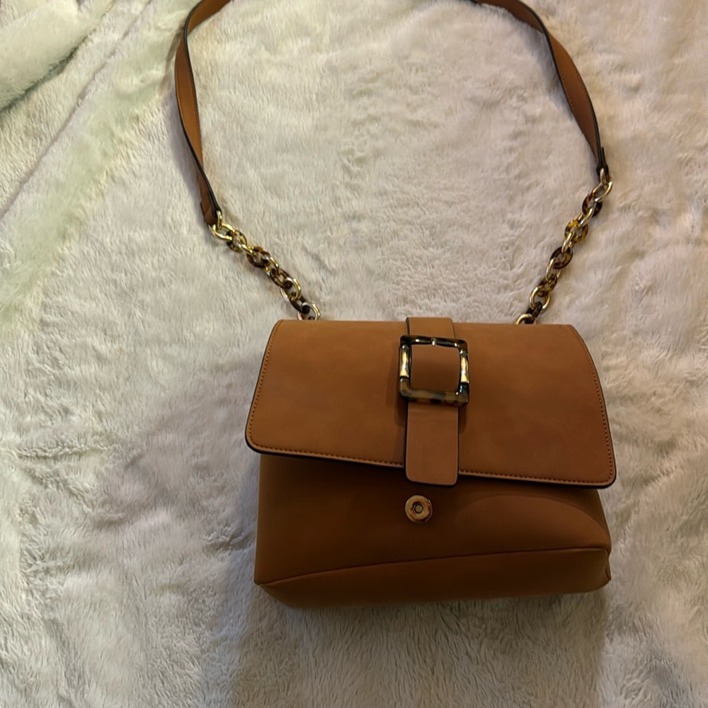 Brown handbag with gold strap.